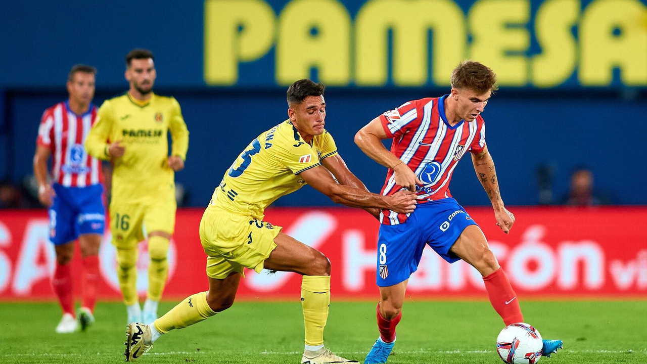 Atletico Madrid and Villarreal players compete for the ball