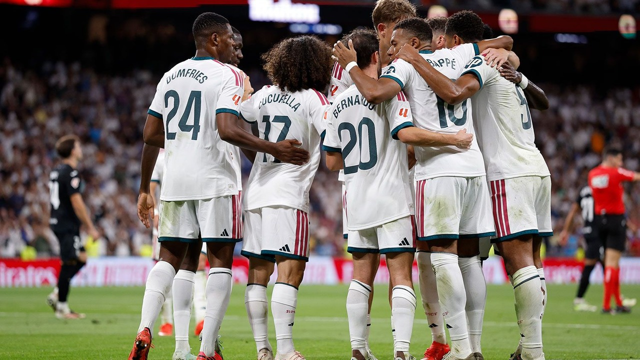 Real Madrid players celebrate together against Real Sociedad