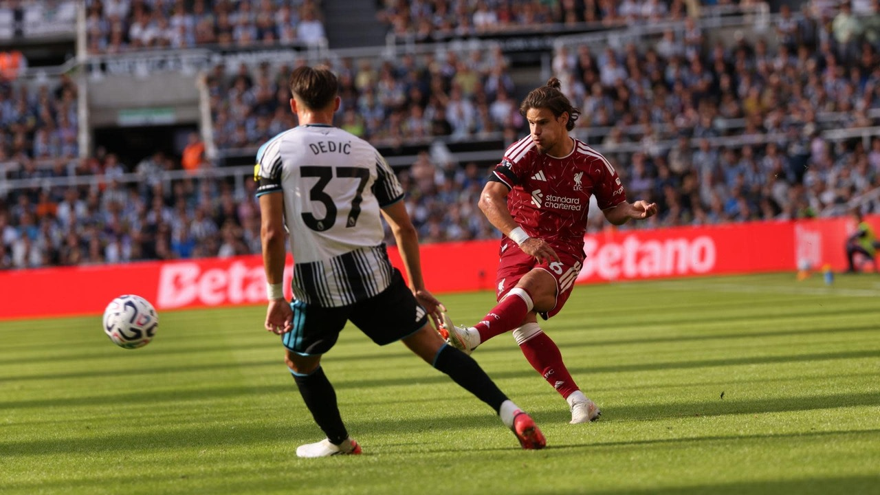 Newcastle and Liverpool players compete for the ball