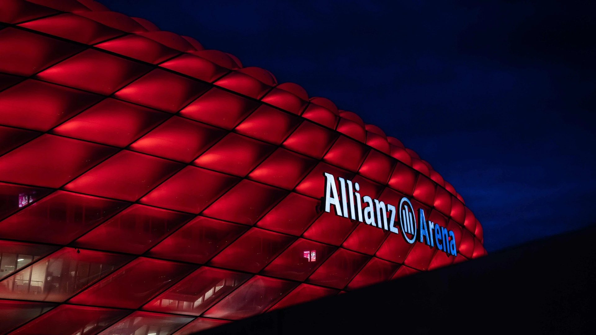 The illuminated exterior of Allianz Arena at night